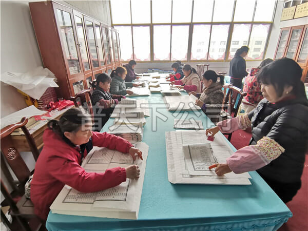 技術(shù)老員工把印好的宗譜折頁(yè)